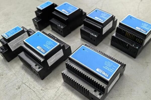 Multiple TPS Din Rail Power Supplies displayed, showcasing the certified series (including models like TPS010-GP, TPS030-GP) with blue labels and rugged industrial design, compliant with UL 61010-1 standard.